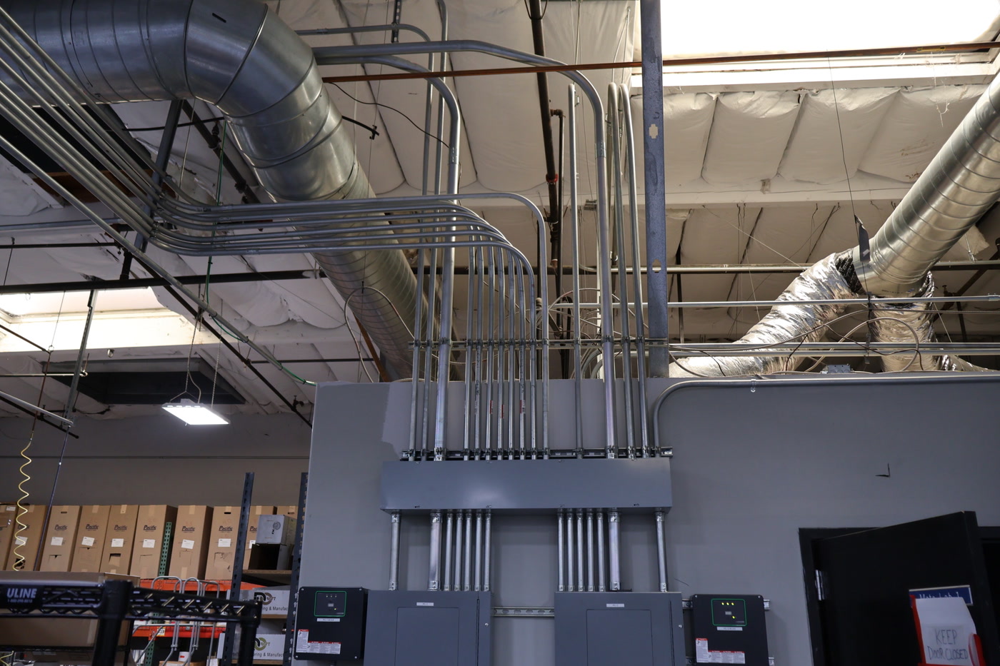 Electrical panels and organized conduit inside an industrial facility