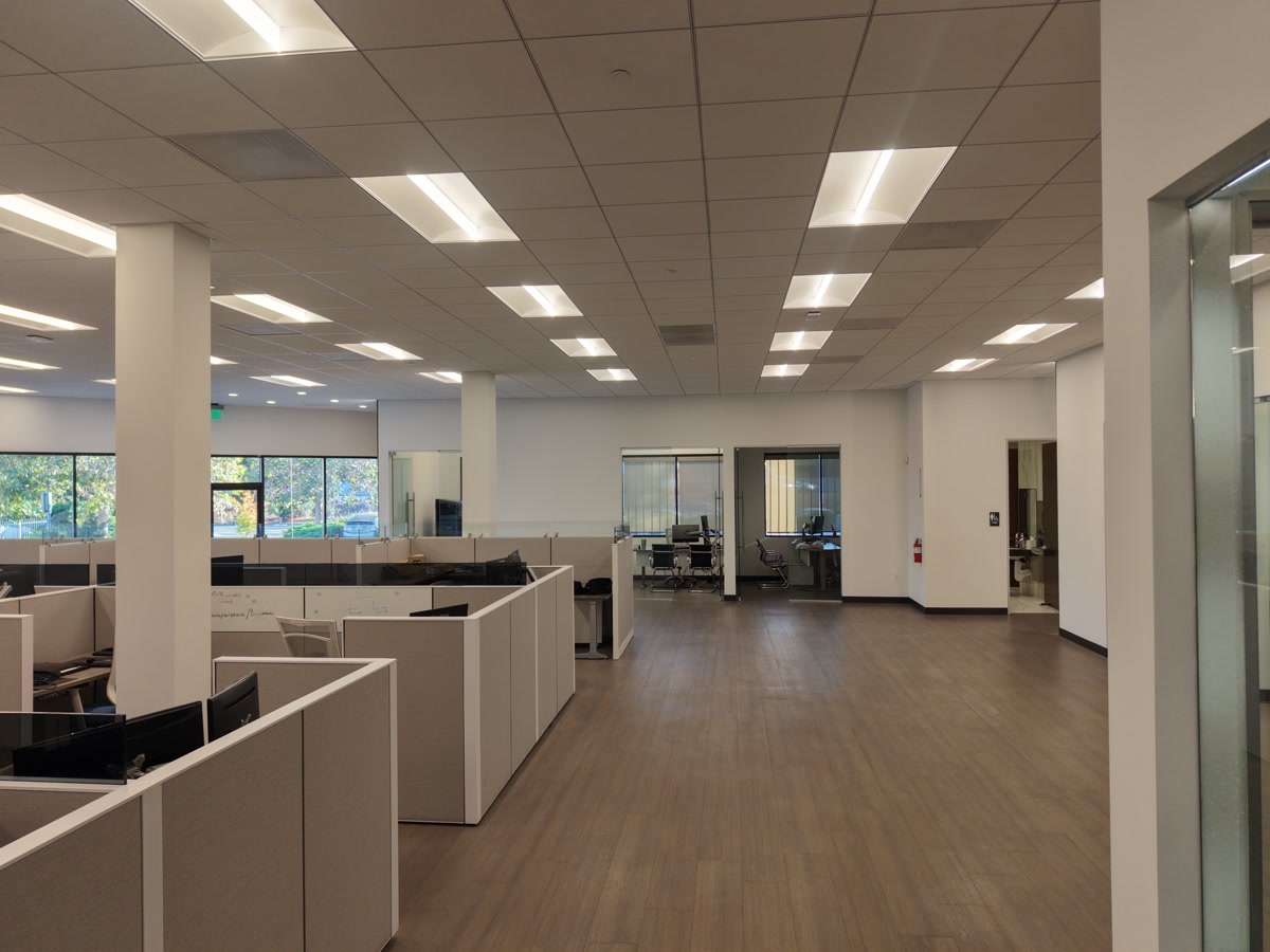 Finished office with cubicles, meeting rooms and ceiling lighting